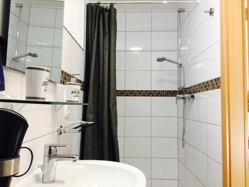 a bathroom with a sink and a shower at Hotel Viktoria in Meersburg
