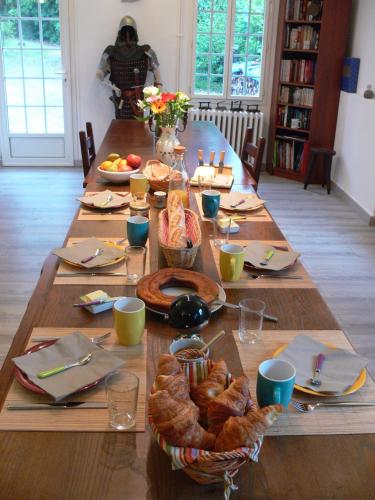 Una larga mesa de madera con un cartel de Acción de Gracias. en Le Clos des Archers, en Laveyssière