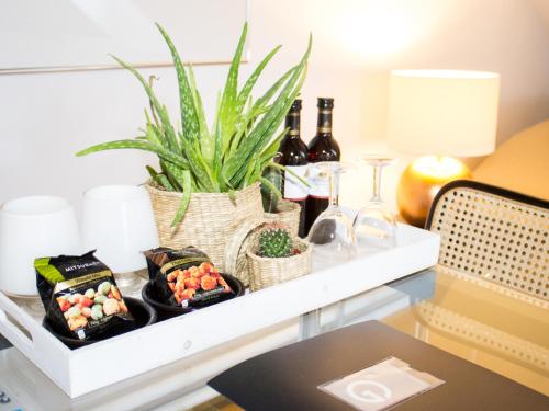 a shelf with food and wine bottles and a plant at Galerie Hotel Dis in Maastricht