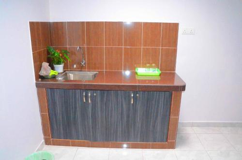 a kitchen with a sink and a counter top at Homestay Klebang Ipoh in Ipoh