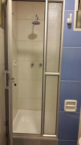 a shower with a glass door in a bathroom at Apart Serma Hotel in Potosí