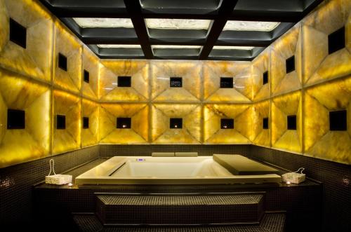 a large bath tub in a bathroom with yellow tiles at Villas Elenite Premium in Elenite