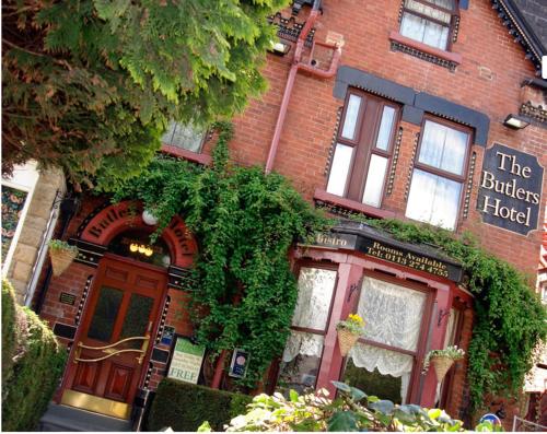a red brick building with a sign for the buffalo hotel at The Butlers Hotel in Leeds
