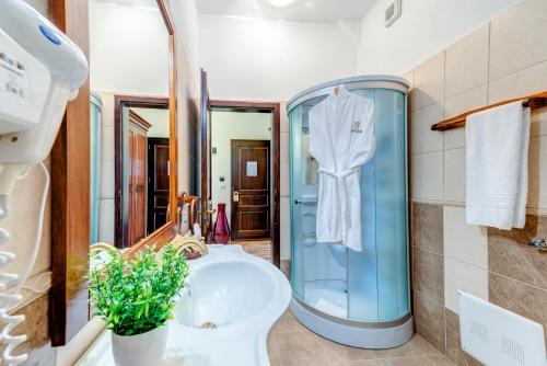 a bathroom with a sink and a toilet and a mirror at Karlhof in Sebeş