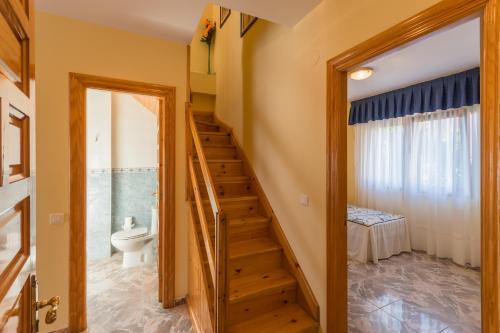 a staircase leading to a bathroom with a toilet at Apartamentos La Bolera in Isla