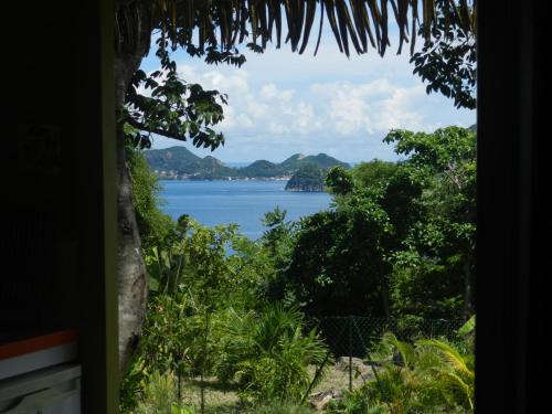 a view of a body of water through a window at Coco D'Iles in Terre-de-Bas
