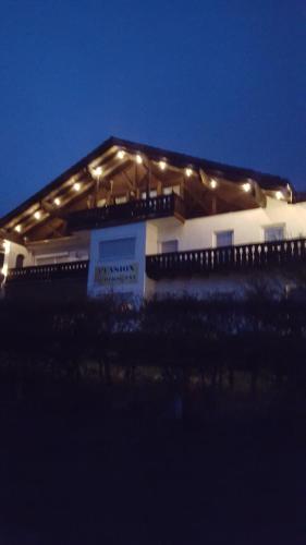 a building with lights on top of it at night at Pension Arbersonne in Bayerisch Eisenstein