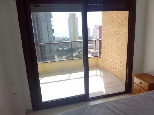 a bedroom with a large window with a view at Franteran in Benidorm