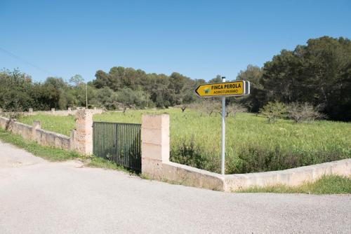 a yellow street sign on the side of a road at Agroturisme Perola - Only Adults in Llucmajor
