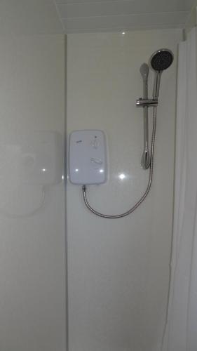 La salle de bains est pourvue d'une douche avec un pommeau de douche. dans l'établissement Glenrothes Central Apartment, à Glenrothes