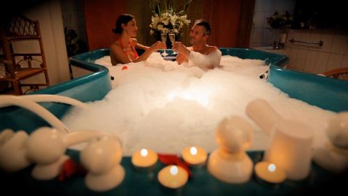 a man and woman sitting in a bath tub at Ensana Sovata in Sovata