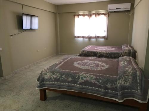 Una cama o camas en una habitación de Hotel Conchita