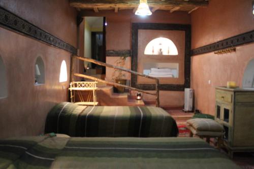 Postel nebo postele na pokoji v ubytování Kasbah ben Ali