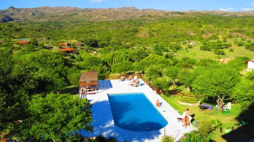 an overhead view of a swimming pool with people around it at Los Ancares Resort in Mina Clavero