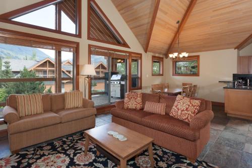 a living room with two couches and a table at Montebello by Whistler Premier in Whistler