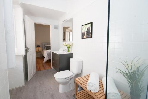 a white bathroom with a toilet and a sink at Cosy Baixa Apartment in Lisbon