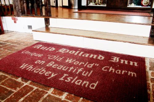 a red welcome mat on the floor of a church at Auld Holland Inn in Oak Harbor