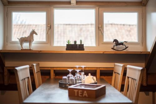 a dining room with a table with a horse statue on it at Op Geneijgen in Grathem