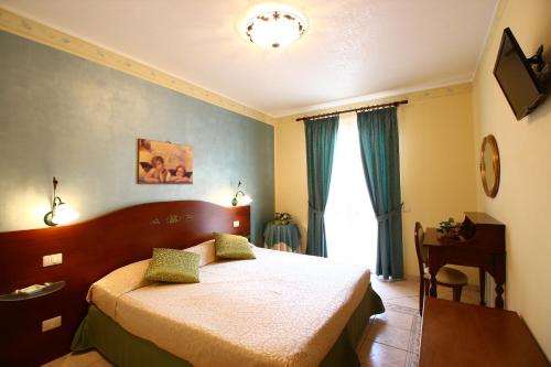 Кровать или кровати в номере Gran Residence Marisa