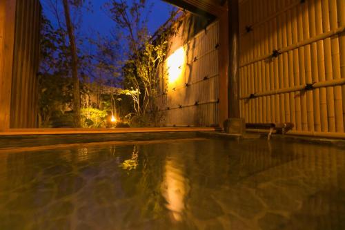 an empty swimming pool in front of a building at night at Yumeoi-so in Aso
