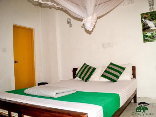 A bed or beds in a room at Green Village