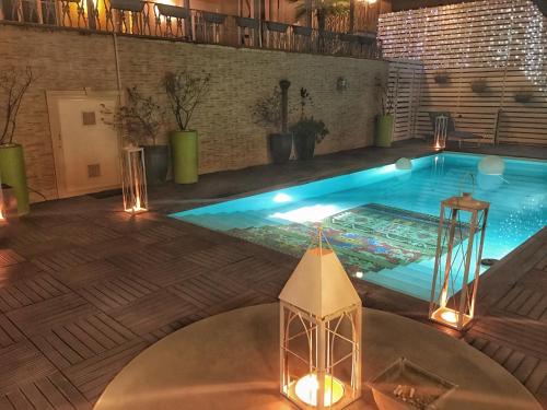 an indoor swimming pool with lights in a building at Hotel Villa del Bosco in Catania