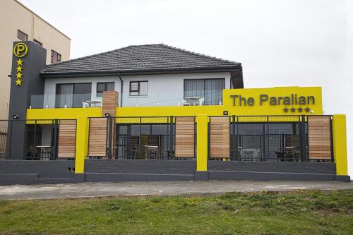 a yellow building with a sign that reads the paritarian at The Paralian Exclusive Guest House in East London