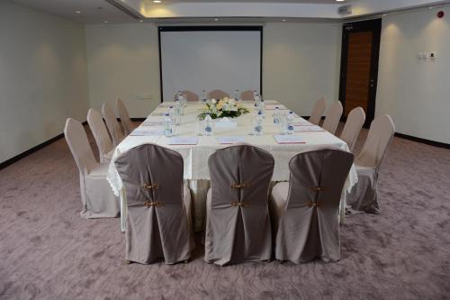 a conference room with a table and chairs at Aryana Hotel in Sharjah