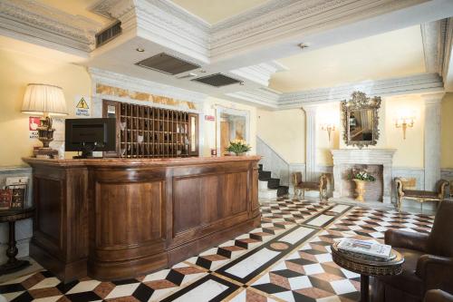 a large lobby with a bar with a fireplace at Hotel Donatello in Rome
