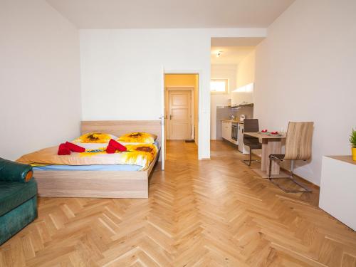 a bedroom with a bed and a living room at Beautiful Central Apartment Thámova in Prague