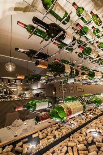 a bunch of wine bottles hanging from a ceiling at Promenáda Romantic Hotel in Karlovy Vary