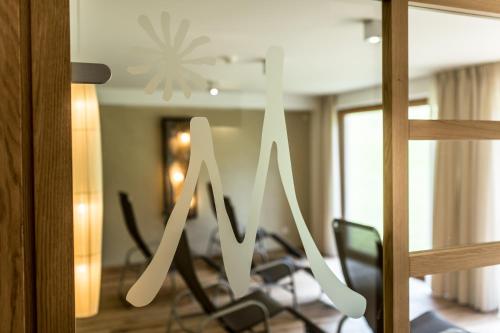 a sign that says m on a window in a room at Hotel Miramonti Badia in Badia