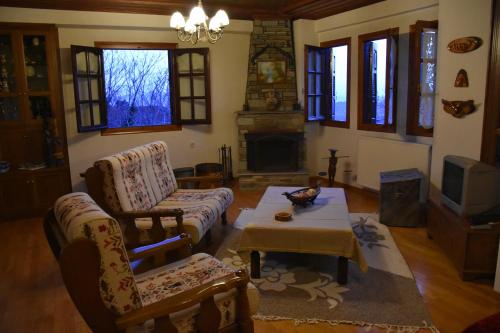 a living room with a couch and a coffee table at Anna's Villa Portaria in Portaria