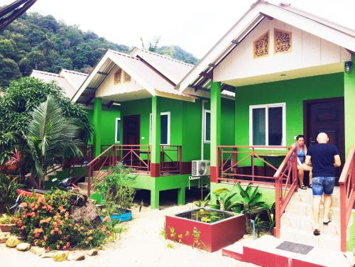 a green house with two people walking into it at Yuyu Golden Beach in Ko Chang