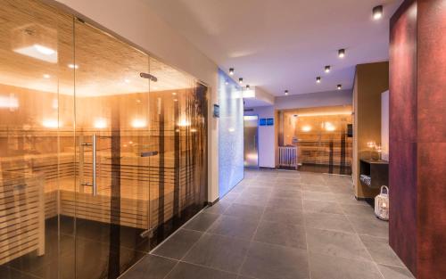 a bathroom with a walk in shower and a glass wall at Apartment Lodge Gasserhof in Bressanone