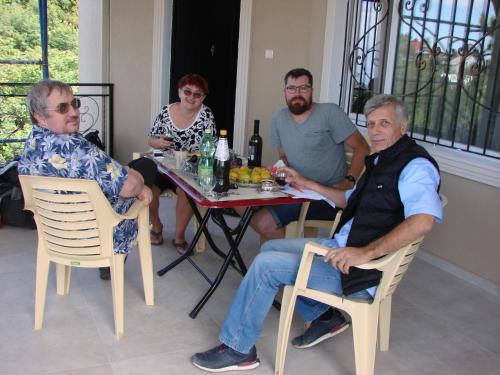 a group of people sitting around a table at Villa Royal House in Makhinjauri