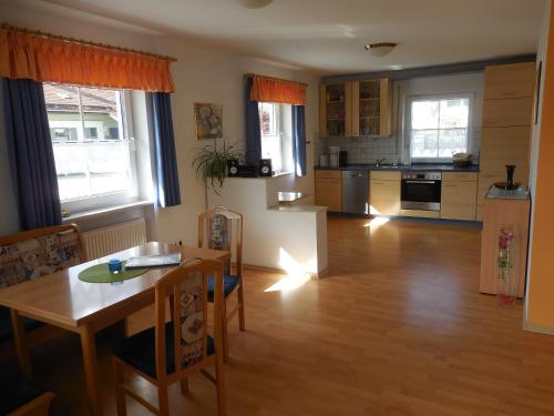 eine Küche und ein Wohnzimmer mit einem Tisch und einem Esszimmer in der Unterkunft Ferienhaus Wellisch in Lohberg