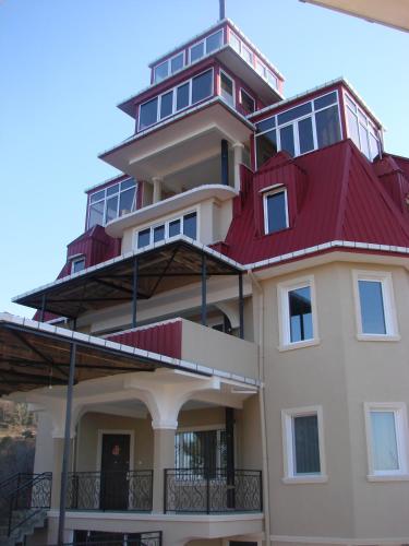 a large building with a red roof at Villa Royal House in Makhinjauri