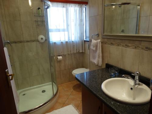 a bathroom with a sink and a shower and a toilet at The Monte Carlo in Centurion