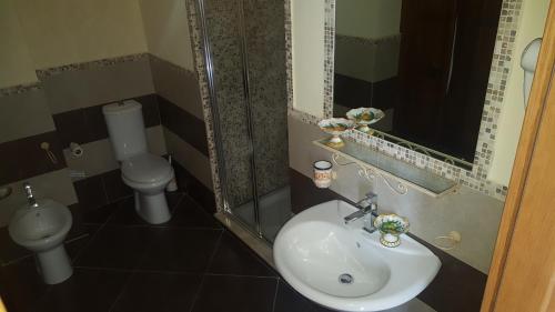 a bathroom with a sink and a toilet at Antico Borgo Petralia in Zafferana Etnea