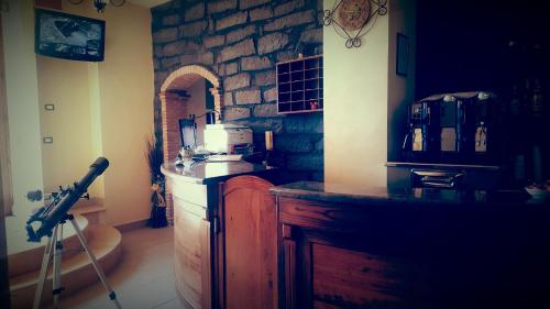 a kitchen with a counter and a stone wall at Antico Borgo Petralia in Zafferana Etnea