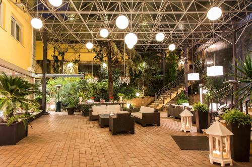 a lobby with tables and chairs in a building at Hotel Villa Traiano in Benevento