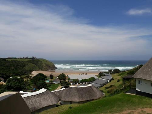 an aerial view of a beach with huts and the ocean at Uberkei in Coffee Bay