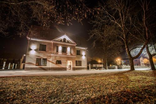a building on a street at night at Park Apartments in Valmiera
