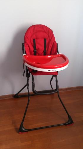 a red chair sitting on top of a wooden floor at Liivakell Holiday Homes in Narva-Jõesuu