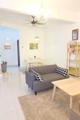 a living room with a couch and a table at Home Sweet Home in Semenyih