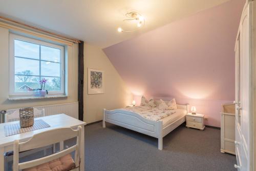 a small bedroom with a bed and a window at Bauernhof Marquardt in Fehmarn