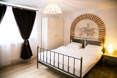 a bedroom with a bed with an arch above it at Hegel Apartment in Sibiu