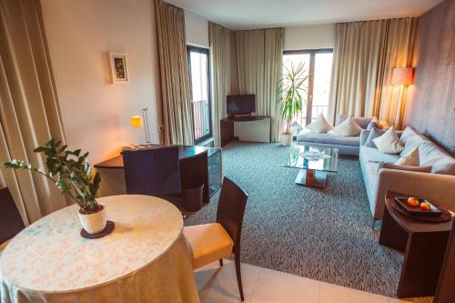 a living room with a couch and a table at Lindenhof Hotel Tepe in Damme