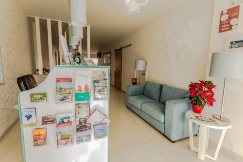 a living room with a couch and a refrigerator at Sea Garden, Residência in Peniche